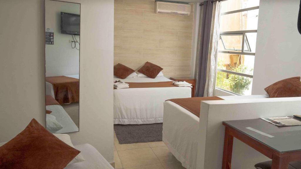Postel nebo postele na pokoji v ubytování Zuruma Hotel