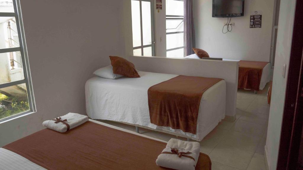 Postel nebo postele na pokoji v ubytování Zuruma Hotel