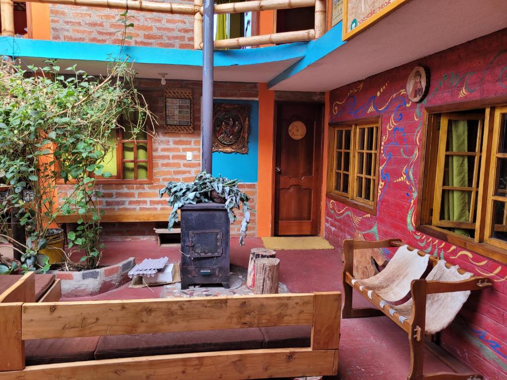 a house with a wood stove in front of it at La Minga Hostal in Salinas