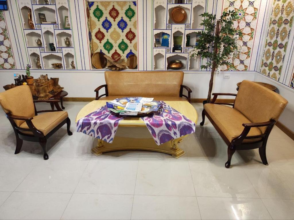 a living room with a table and two chairs at Nostalgia Boutique Hotel in Bukhara