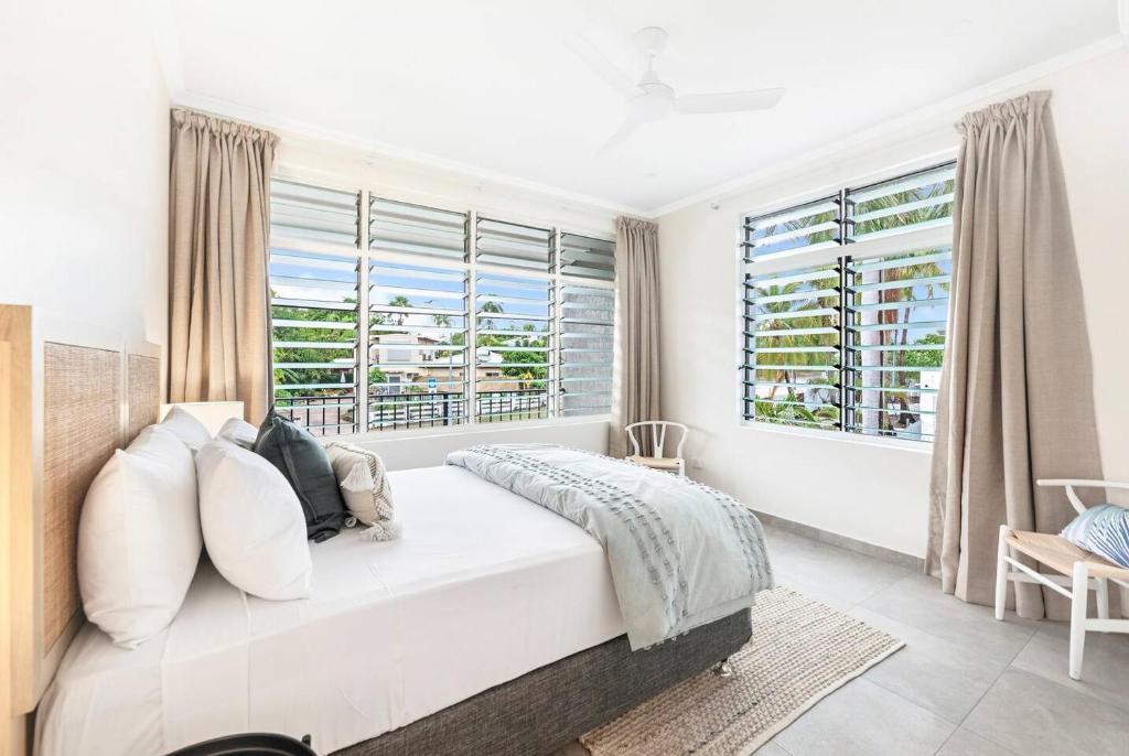 a bedroom with a large bed and a large window at 'Botanica Hoja' A Nightcliff Balcony Refresh in Nightcliff