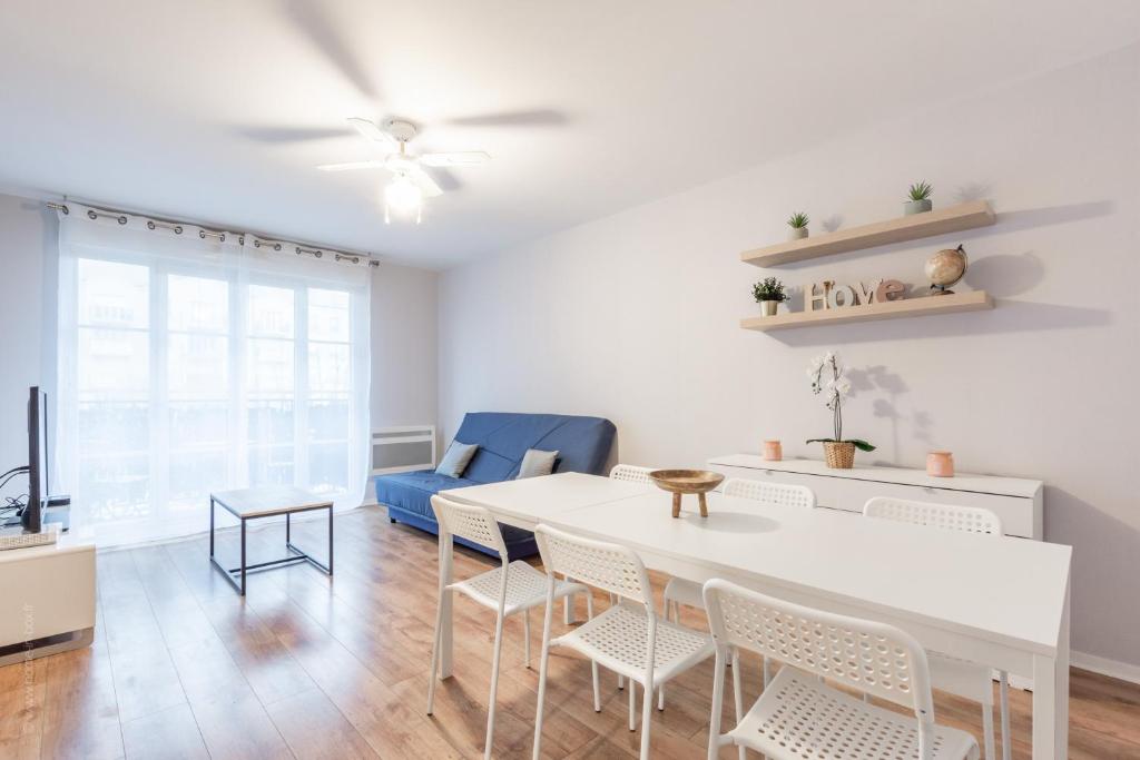 a living room with a white table and chairs at Mindset for 7 - Fairytale Factory in Bussy-Saint-Georges