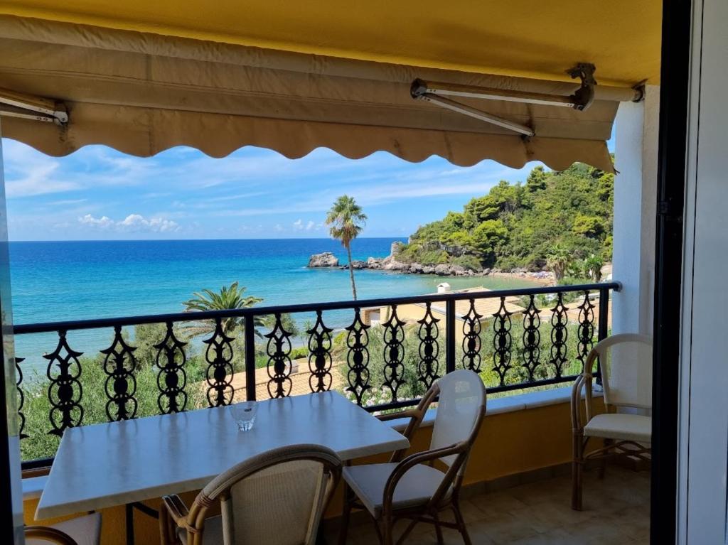 a balcony with a table and a view of the ocean at Corfu Glyfada Beach Apartment 46 in Glyfada