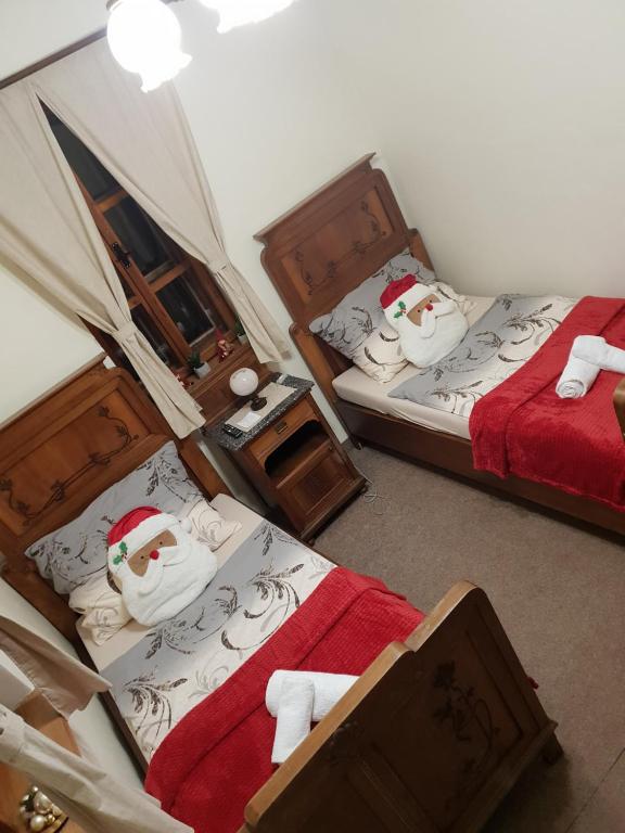 a bedroom with two beds with santa hats on them at Penzión Šafran in Stratená