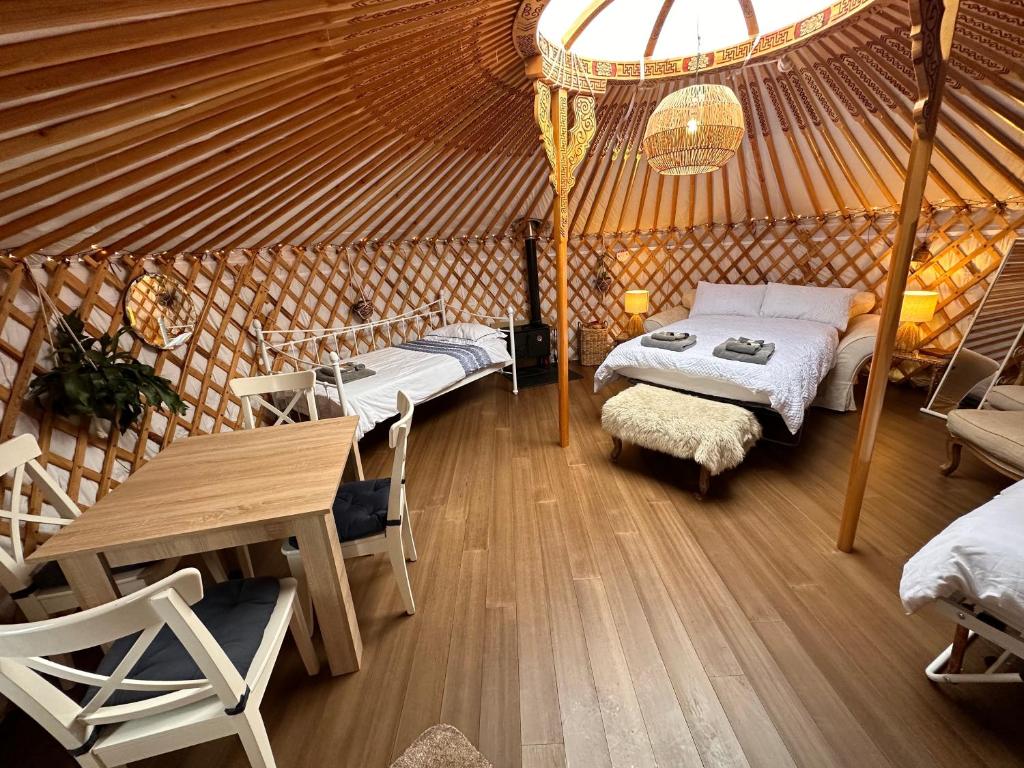 a room with two beds in a yurt at Buzzard Holt Hosting in Buckingham
