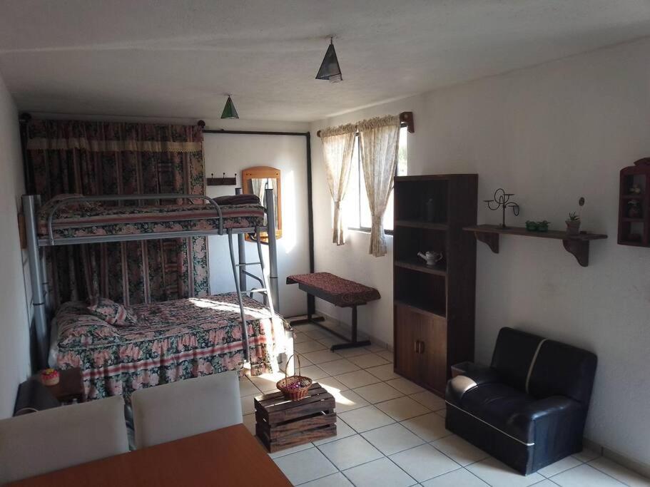 a living room with a bedroom with bunk beds at Sweet Home in Tequisquiapan