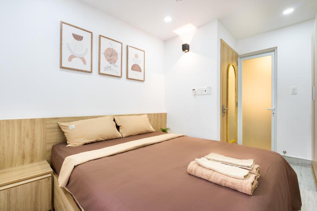 Giường trong phòng chung tại Ekomo Home - Central Saigon
