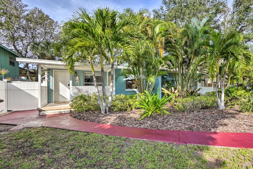 a house with palm trees in front of it at Indian Rocks Beach Duplex, Close to Beaches! in Clearwater Beach
