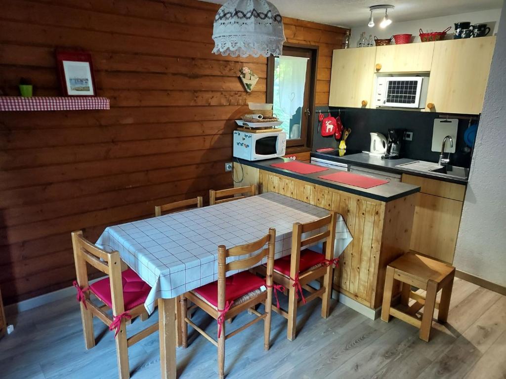 a kitchen with a table and chairs and a counter at Appartement Châtel, 3 pièces, 6 personnes - FR-1-198-104 in Châtel