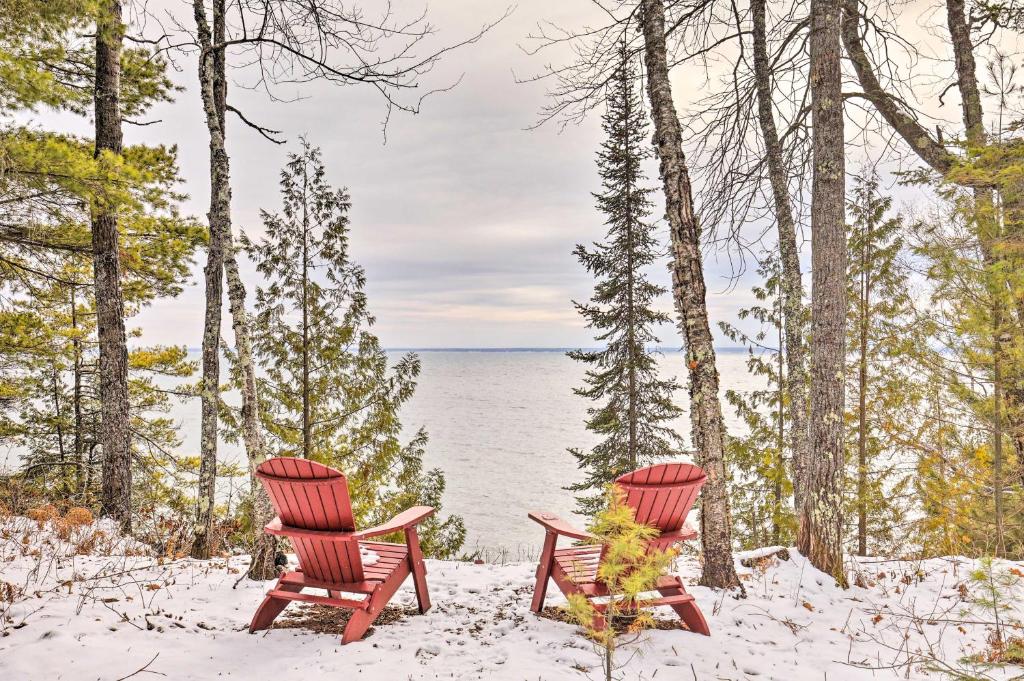dos sillas sentadas en la nieve junto al agua en Cabin on Lake Superior about 11 Mi to Bayfield!, en Washburn