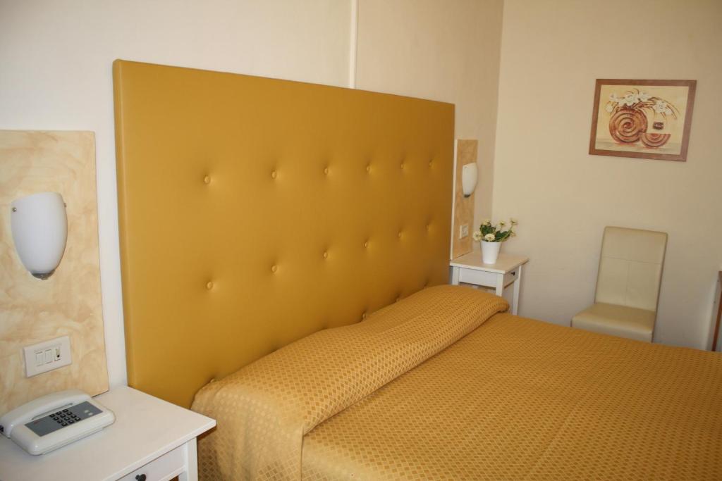 Postel nebo postele na pokoji v ubytování Albergo Il Giglio