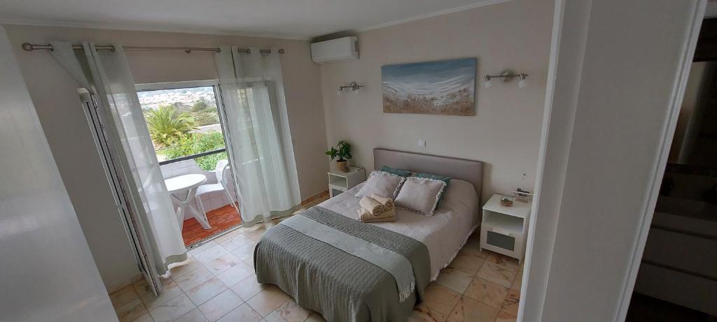 a bedroom with a bed and a large window at Lagos Apartment Sea View in Lagos