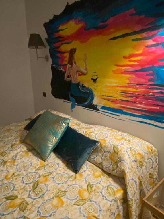 sypialnia z obrazem na ścianie i łóżkiem w obiekcie Partenope Comfort w mieście Napoli