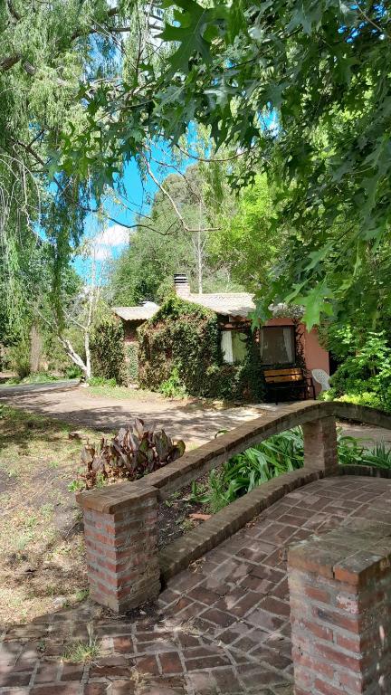 a stone bench in front of a house at Cabañas Las Dinas in Tandil
