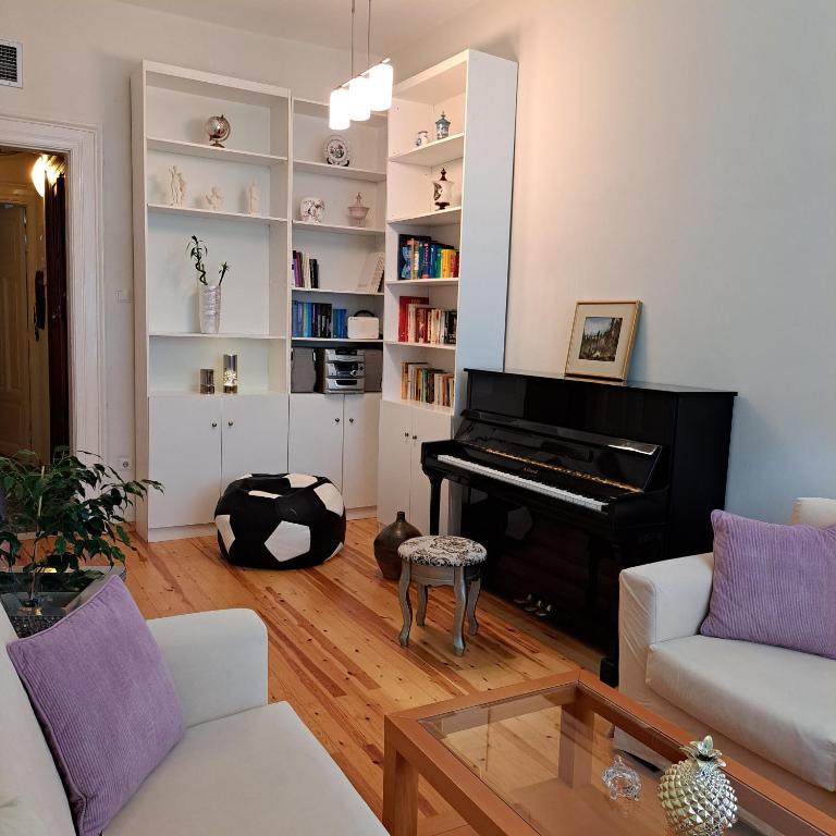 a living room with a piano and a couch at Maria's apartments in Thessaloniki
