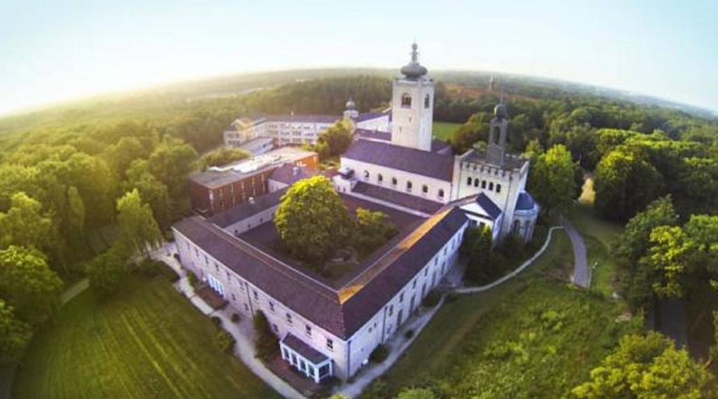 an aerial view of a large building with a tower at Leerhotel Het Klooster in Amersfoort