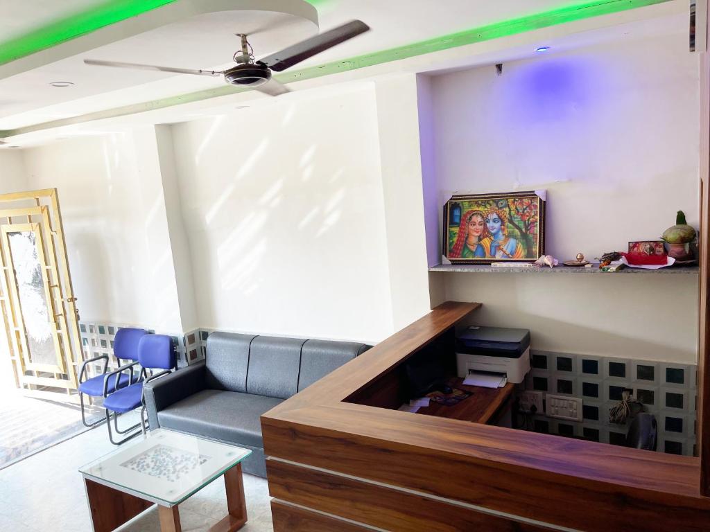 a living room with a couch and a ceiling fan at Hotel Seven INN in Puri