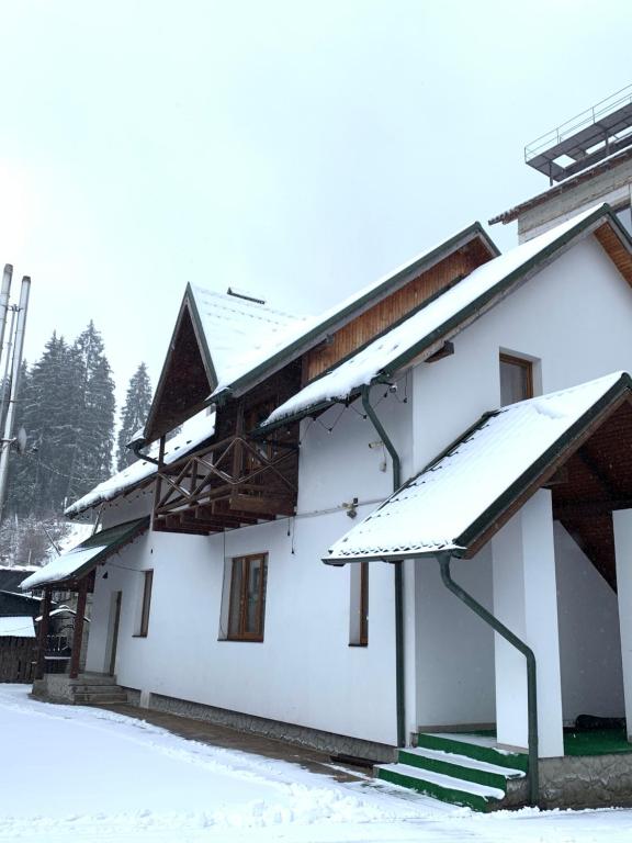 a white building with snow on it at Proskurov Holiday Home in Bukovel