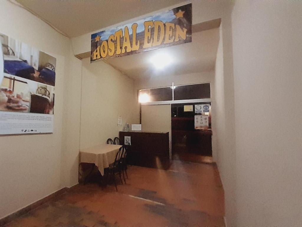 a room with a table and a sign for a baseball dealer at HOSTAL EDEN in Torotoro