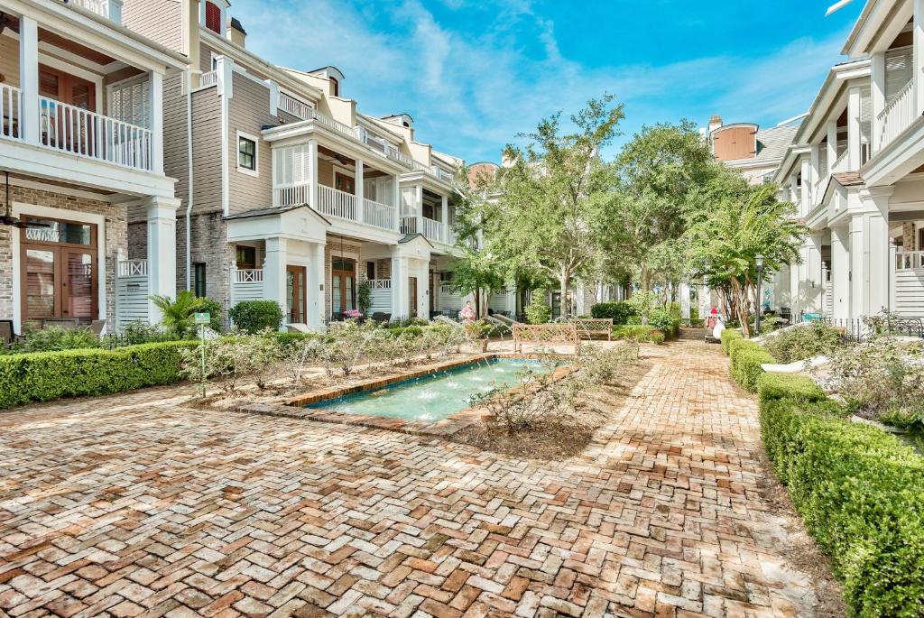 a home with a brick driveway and a swimming pool at Le Jardin 154 in Destin