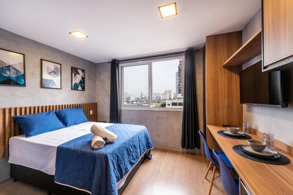 1 dormitorio con cama, escritorio y ventana en MV53 - Encanto nas Proximidades da Estação Brás: Seu Estúdio Acolhedor!, en São Paulo