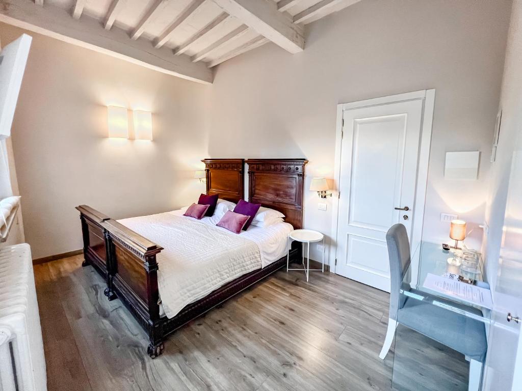 a bedroom with a bed with purple pillows at B&B Palazzo Bruchi in Siena
