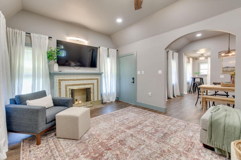 a living room with a fireplace and a table at Charming 2 bed 1 bath Tudor - Near Plaza & Midtown in Oklahoma City