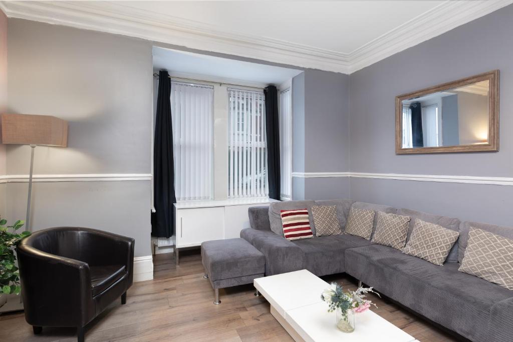 a living room with a couch and a chair at City Centre Large Luxury Rooms Free Parking in Gateshead