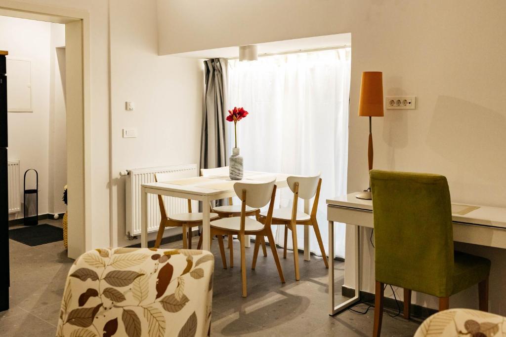 a kitchen and dining room with a table and chairs at Vila Jakopič apartments in Ljubljana