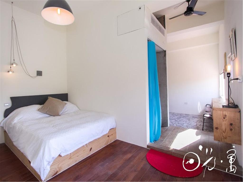 Postel nebo postele na pokoji v ubytování Kenting Sun Light Inn