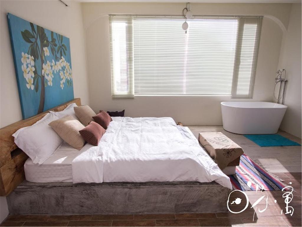 Postel nebo postele na pokoji v ubytování Kenting Sun Light Inn