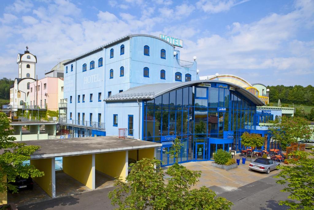 ein großes blaues Gebäude mit einem Uhrturm in der Unterkunft Hotel Strohofer in Geiselwind