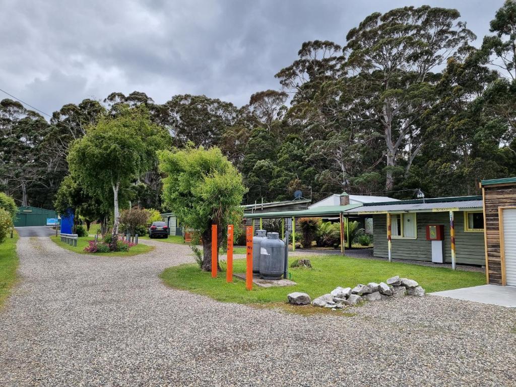 a gravel driveway in front of a house at Strahan Backpackers in Strahan