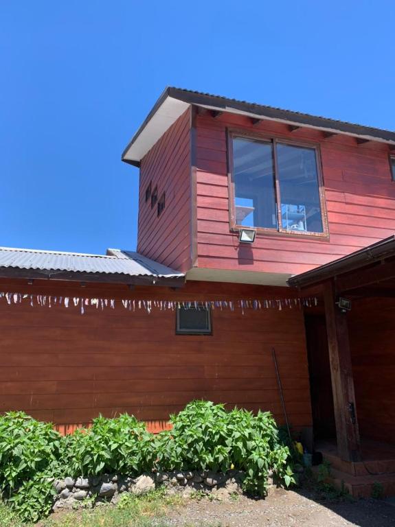 a red house with a window on top of it at Ruka Experience in Pucón