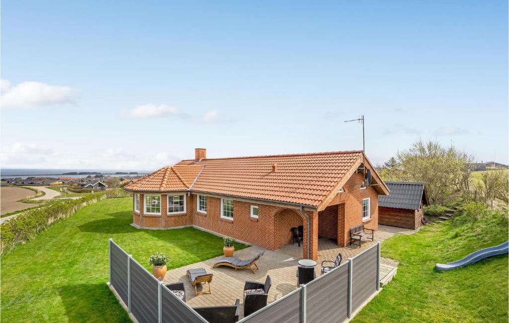 a house with a large backyard with a slide at Awesome Home In Lemvig With Kitchen in Lemvig