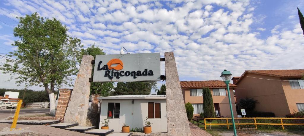 a sign for a la tropologias restaurant in front of a building at Hotel La Rinconada Tequisquiapan in Tequisquiapan