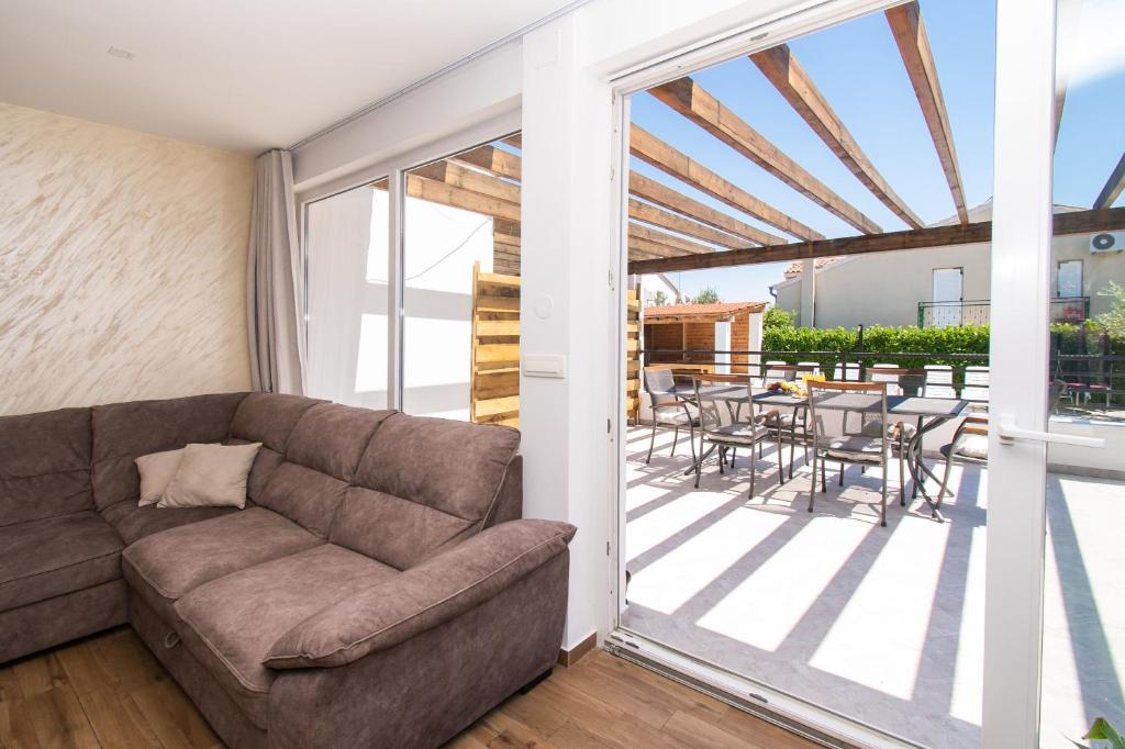 a living room with a couch and a patio at Villa Divine in Vodice