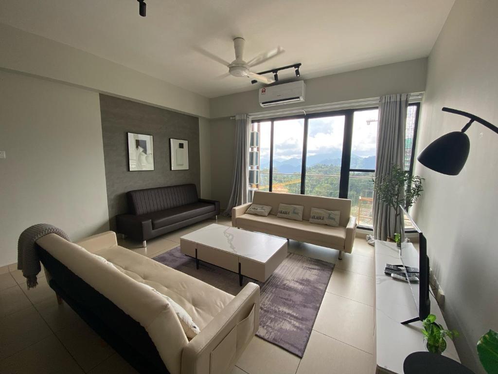 a living room with a couch and a table at Cloud 9 Suite - Midhills Genting Highland in Genting Highlands