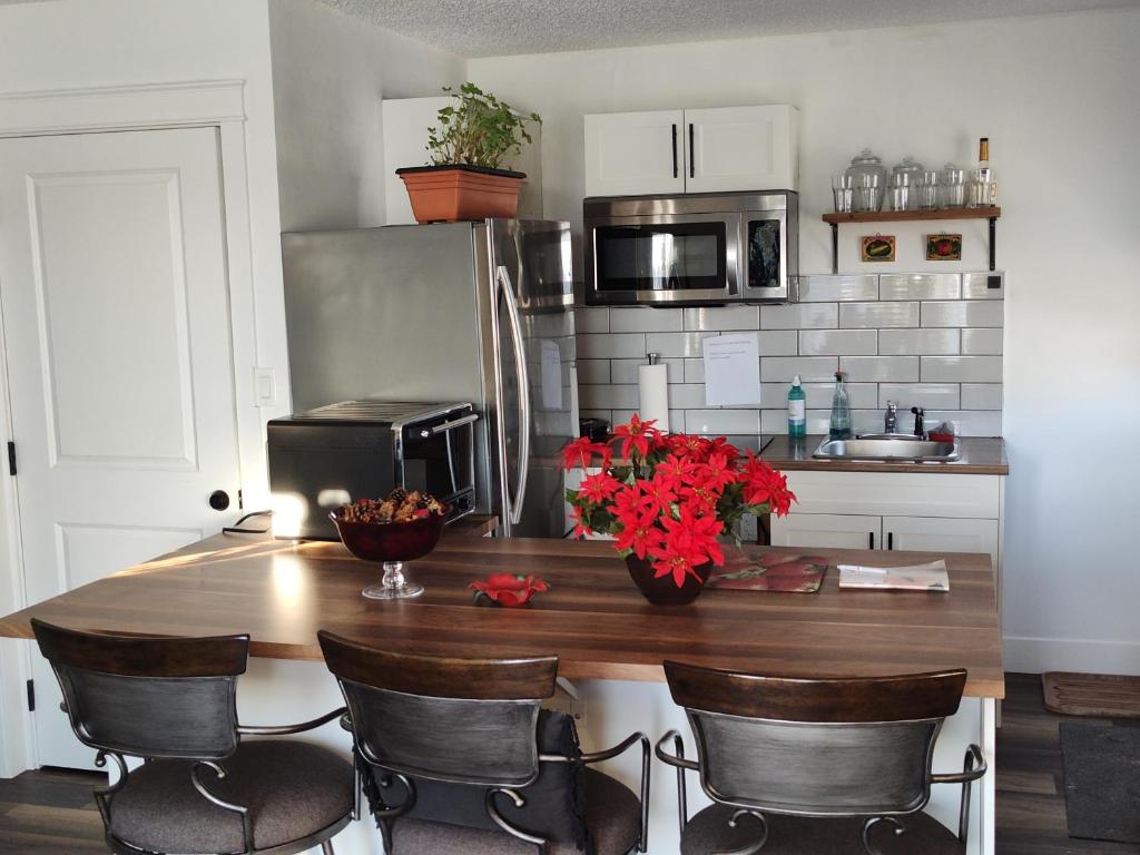 a kitchen with a counter with red flowers on it at Tranquil & Tasteful One Bdrm Private Suite NE in Edmonton