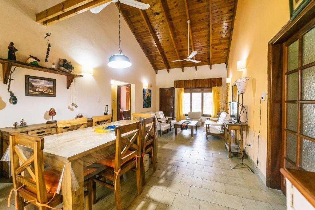 a dining room and living room with a table and chairs at LA PAZ in Sierra de la Ventana