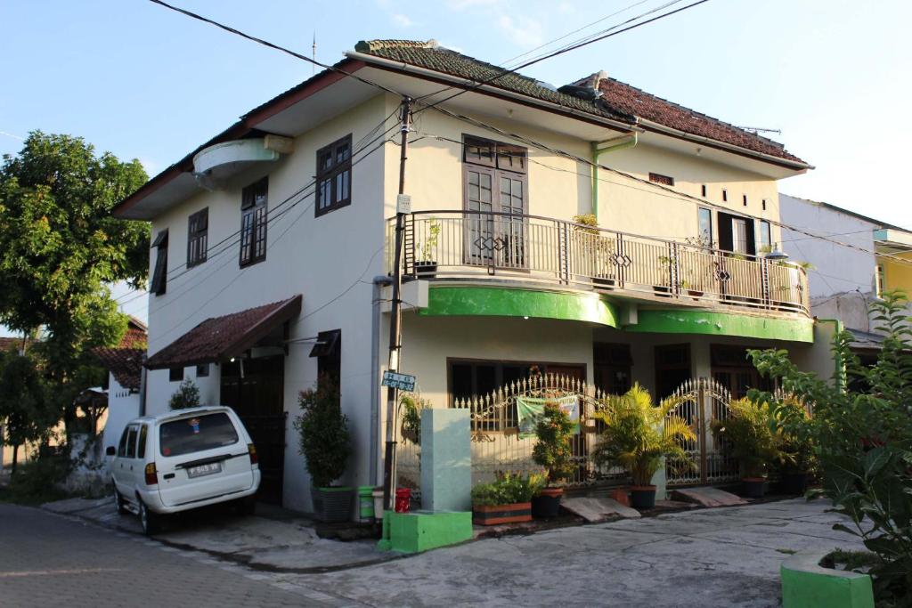 a white car parked in front of a building at Kost&Guesthouse Tirza in Banyuwangi