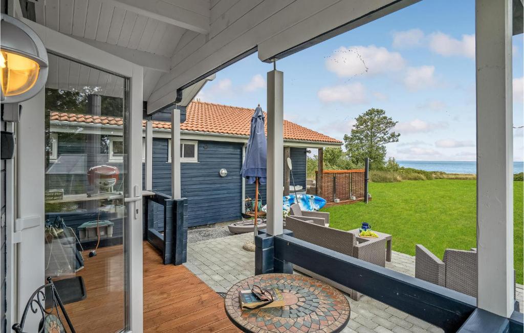 a patio with a view of the ocean from a house at Cozy Home In Kalundborg With Kitchen in Kalundborg