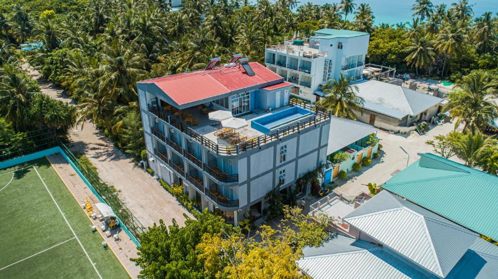 an overhead view of a building with a red roof at Dhiguveli Breeze in Dhigurah