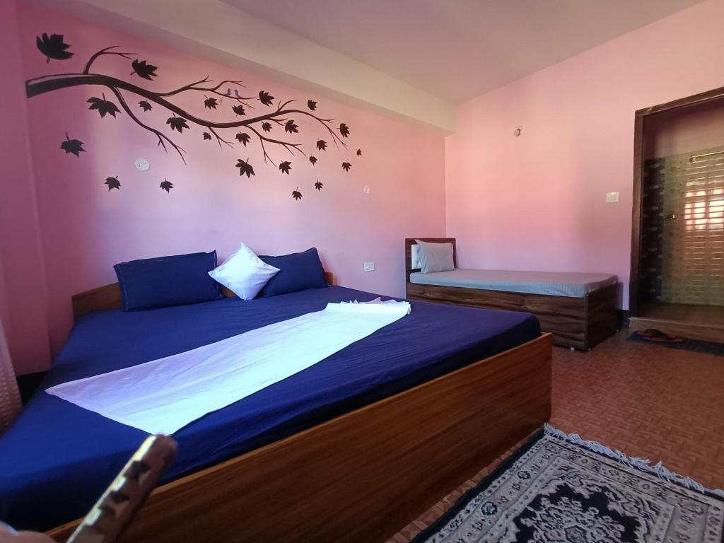 a bedroom with a bed with a branch on the wall at Wind Valley Homestay in Pelling