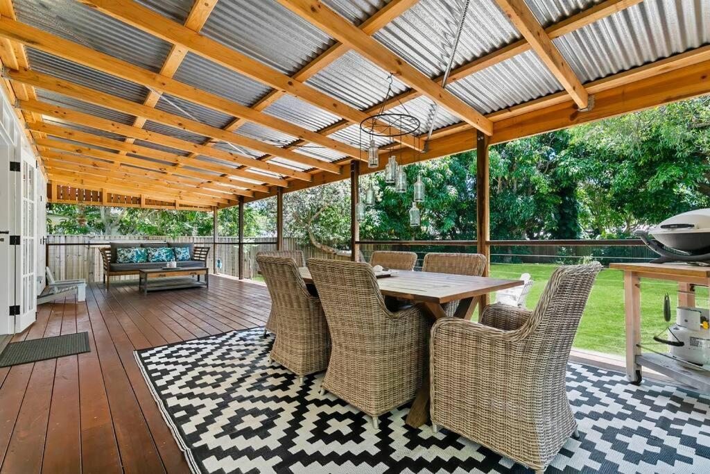 a patio with a table and chairs on a deck at Bon Cottage in Woorim