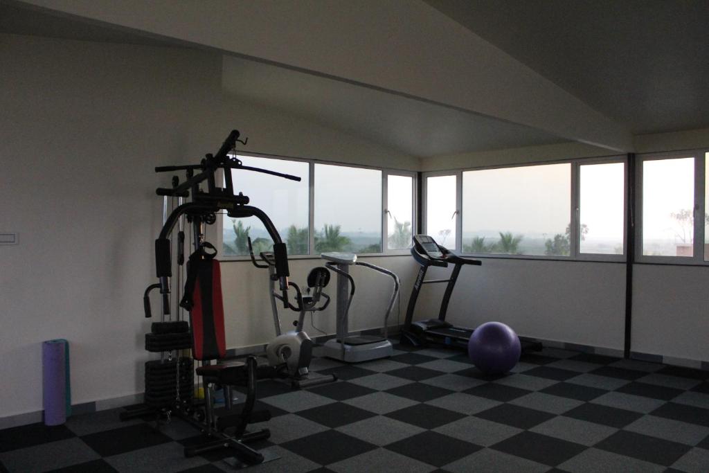 a gym with two treadmills and exercise bikes at Flamingo Club and Resort Una 3 Km Away from Diu Check Post in Diu