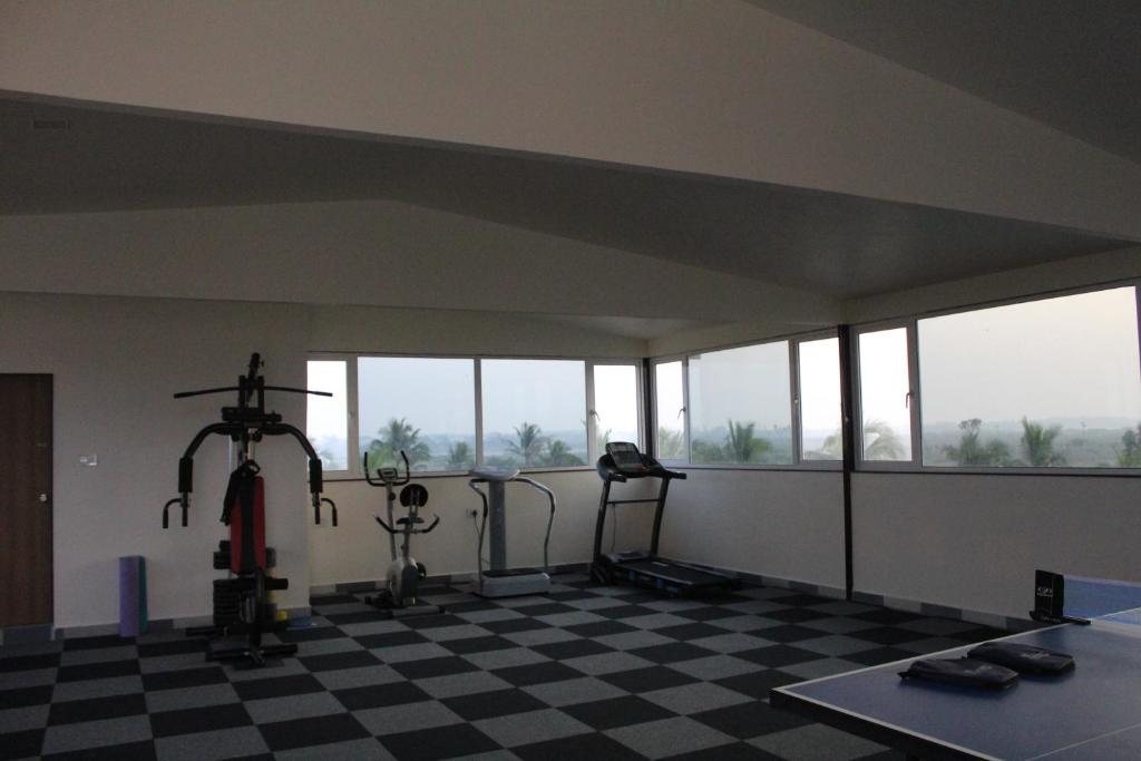 a gym with two exercise bikes and a room with windows at Flamingo Club and Resort Una 3 Km Away from Diu Check Post in Diu