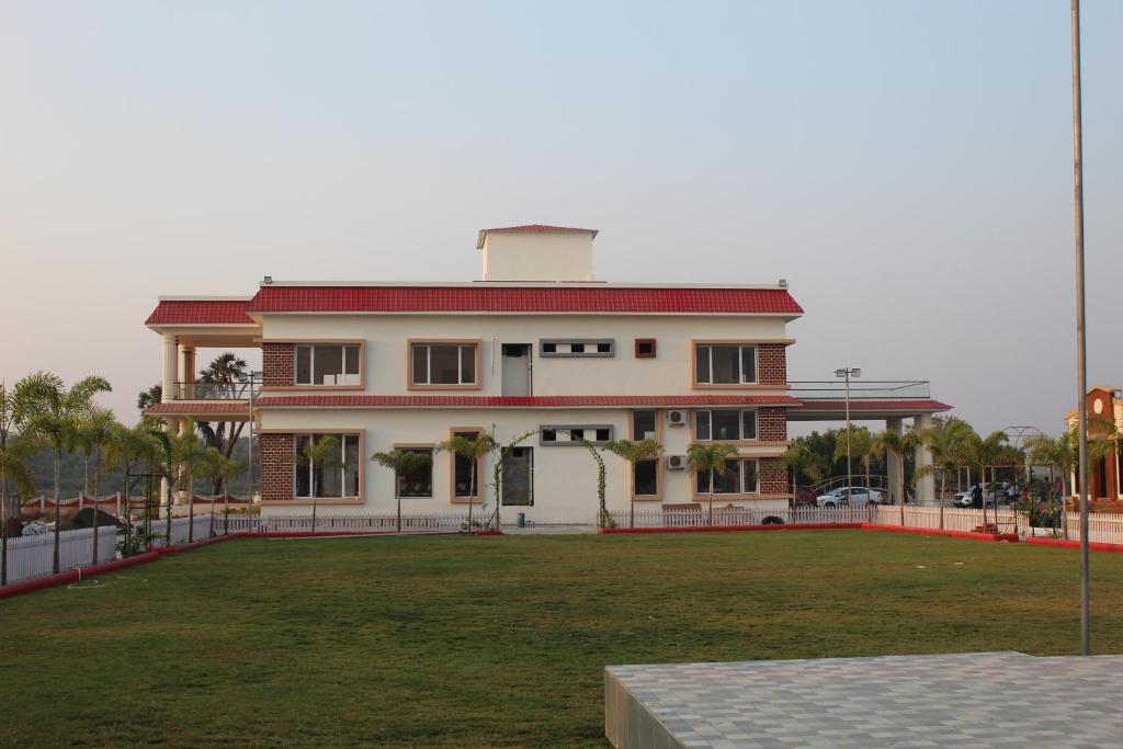 a large house with a large lawn in front of it at Flamingo Club and Resort Una 3 Km Away from Diu Check Post in Diu