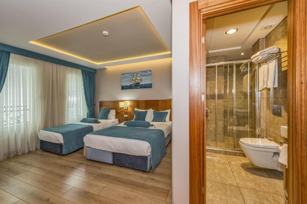 A bed or beds in a room at The Meretto Hotel Istanbul Old City