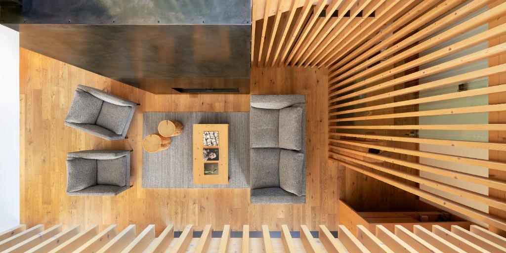 an overhead view of a living room with two chairs at Saleghes Dolomites Residence in Selva di Val Gardena